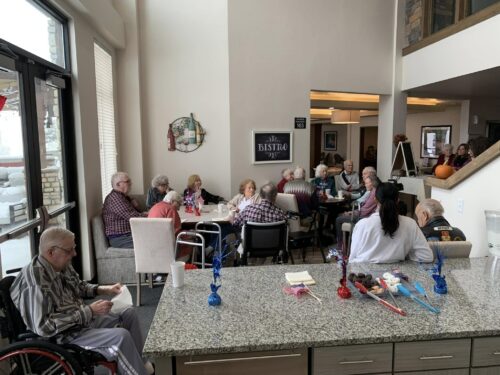 Group-Of-Senior-Residents-At-Golden-Lodge-Gathered-At-The-Bistro